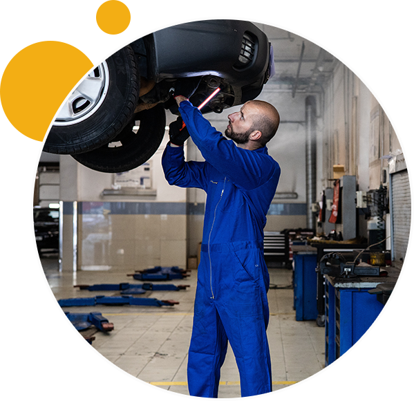 Mechanic checking underbody of the car